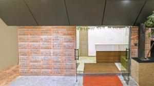 a room with a brick wall and a window at Abhilashaa Inn in Pachmarhī
