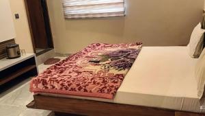 a bed in a room with at Abhilashaa Inn in Pachmarhī