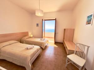 a hotel room with two beds and a balcony at Villa Matilde Amalfi in Amalfi
