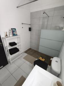 a white bathroom with a shower and a toilet at Michelle Mediterranean Suites in Meneou +32 photos