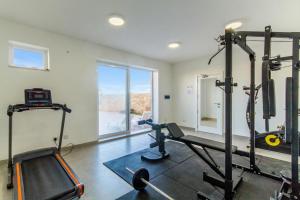 a room with a gym with a treadmill and a window at Wellness Hygge Modern Gozitan Apartment - Happy Rentals in Taʼ Sardina