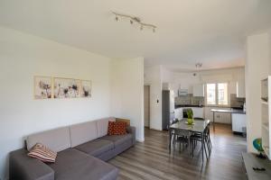 a living room with a couch and a table at Arlu lake house Lazise in Lazise