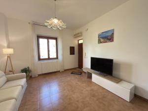 a living room with a couch and a flat screen tv at Villa Matilde Amalfi in Amalfi