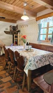 a dining room with a table and some chairs at Hiša Vasenka in Laze v Tuhinju