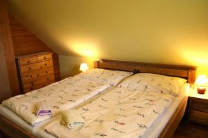 a large bed in a bedroom with two lamps at Chata pod Lazíkom in Liptovský Hrádok