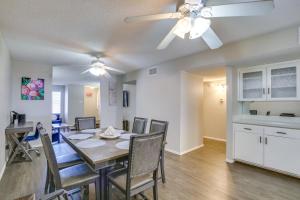 a dining room with a table and chairs and a ceiling fan at Remote Work Ready! Central Yuma Condo w/ Patio in Yuma