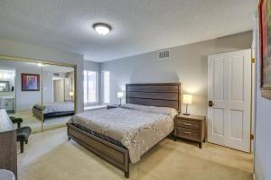 a bedroom with a large bed and a mirror at Remote Work Ready! Central Yuma Condo w/ Patio in Yuma +17 photos