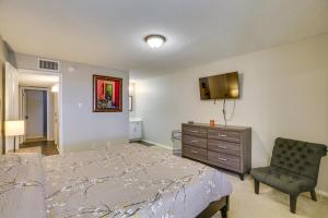 a bedroom with a bed and a chair and a dresser at Remote Work Ready! Central Yuma Condo w/ Patio in Yuma