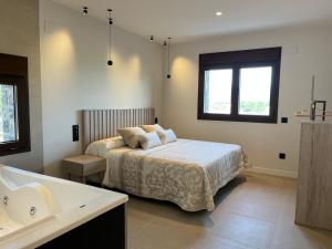 a bedroom with a bed and a bath tub at Casas Pirineo, Ainsa in Aínsa