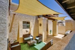 an outdoor patio with chairs and tables and a building at Remote Work Ready! Central Yuma Condo w/ Patio in Yuma