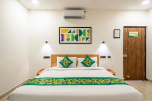 a bedroom with a large bed in a room at Treebo The Trio, Karmanghat in Hyderabad