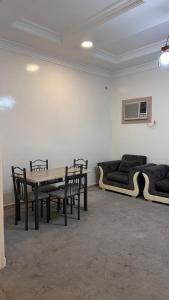 a room with a table and chairs and a couch at شقق ركن التاسيس in Najran +9 photos