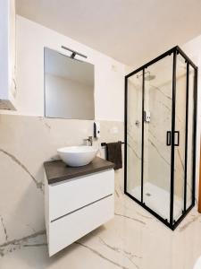 a bathroom with a sink and a glass shower at Milano Brenta Suites Room for 2 in Milan +7 photos