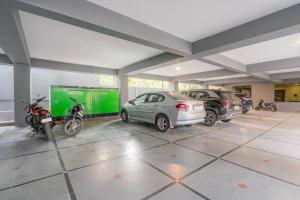a garage with cars and motorcycles parked in it at Treebo The Trio, Karmanghat in Hyderabad