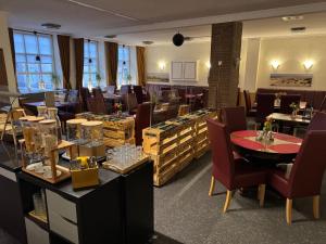 a restaurant with tables and chairs and a room filled with items at Hotel Hinz in Bad Oldesloe