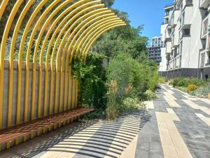 a wooden fence with a bench next to a building at Itown Apartments in Odesa