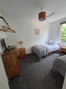 a bedroom with two beds and a window at St Marys Cottages 1 in Dover