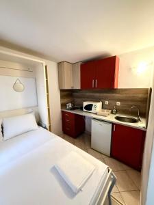 a small room with a bed and a sink at Majka 2 Apartments in Kotor