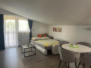a bedroom with a bed and a table and chairs at Apartments Dora in Poreč