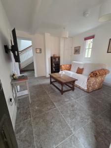 a living room with a couch and a table at St Marys Cottages 1 in Dover