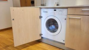 a washing machine in a kitchen under a counter at Vigo a un paso in Vigo