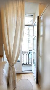 a bedroom with a bed and a large window at Vigo a un paso in Vigo