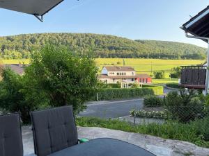 a table and chairs on a patio with a house at Fewo-Welz in Bad Kissingen