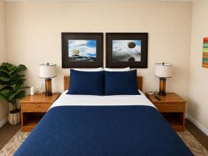 a bedroom with a blue bed with two pictures on the wall at Poolside Retreat at Kimberling Crossing in Kimberling City +29 photos