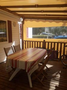 a table and two chairs on a porch at danseuse 33 in Parentis-en-Born