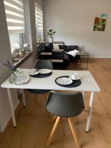 a white table and chairs in a living room at Eifelliebe in Bergweiler