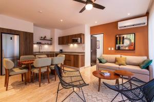 a living room with a couch and a table at Ceiba 25 by Andiani Travel in Playa del Carmen +25 photos