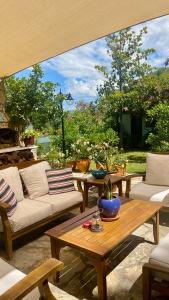 a patio with couches and a table and a view of a garden at Kamarca House Hotel in Ortaca