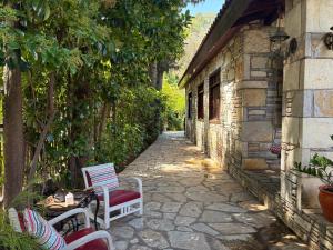 a stone alley with chairs and a building at Kamarca House Hotel in Ortaca