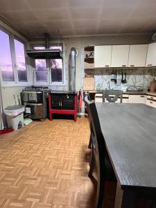 a kitchen with a table in the middle of it at La Casona - Refugio Austral in Punta Arenas