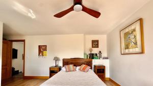 a bedroom with a ceiling fan and a bed at Matxiku Aurre in Berástegui
