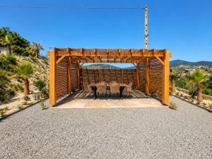 a gazebo with two tables and chairs in it at L'Écrin de Nature Panoramic View & Prestige in Saint-Marcel-lès-Annonay