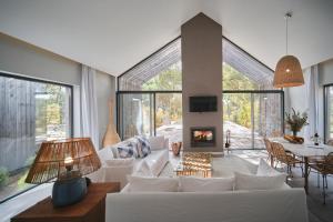 a living room with white furniture and a fireplace at Sublime Comporta in Comporta