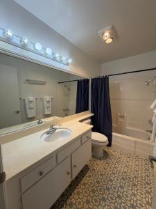 a bathroom with a sink and a toilet and a tub at Coastal Comfort in Oxnard +30 photos
