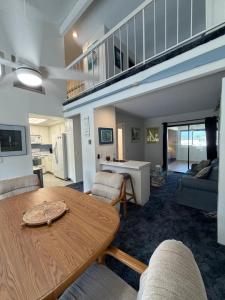 a living room with a wooden table and chairs at Coastal Comfort in Oxnard