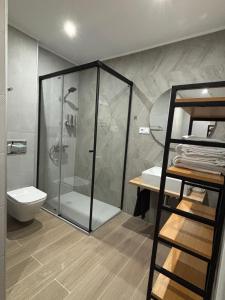 a bathroom with a shower and a toilet at Al Mar pensión in Alicante +59 photos