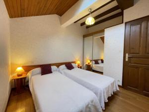 a bedroom with two beds with white sheets at Iagonia in Lacarry-Arhan-Charritte-de-Haut