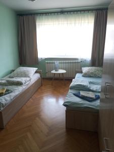 two beds in a room with a window at villa in Nowa Ruda