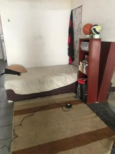 a bedroom with a bed and a book shelf at Wesley in São Luís