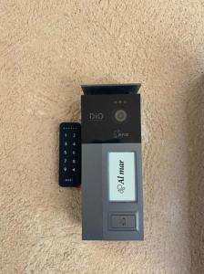 a dvd player and a remote control sitting on a table at Al Mar pensión in Alicante