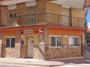 a building on a street with a no entry sign at Al Mar pensión in Alicante