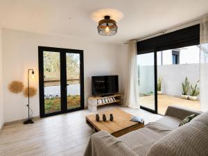 a living room with a couch and a table at Villa des trois singes in Saint-Pierre