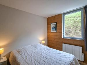 a bedroom with a large bed and a window at Spacieux appartement 3 pièces au centre de Flaine - FR-1-425-28 in Flaine