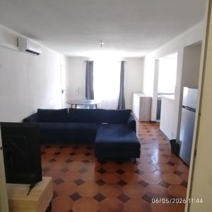 a living room with a couch and a table at Tikanel in Schœlcher