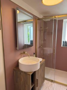 a bathroom with a sink and a shower at Little Rozel in East Grinstead