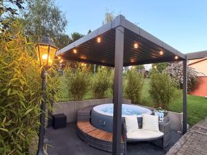 a gazebo with a hot tub in a backyard at Ferienhaus mit Whirlpool, Garten und großer Terrasse ruhig privat in Herbstein